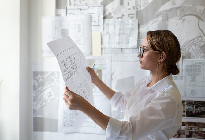 An intelligent female architect analyzing a floor plan