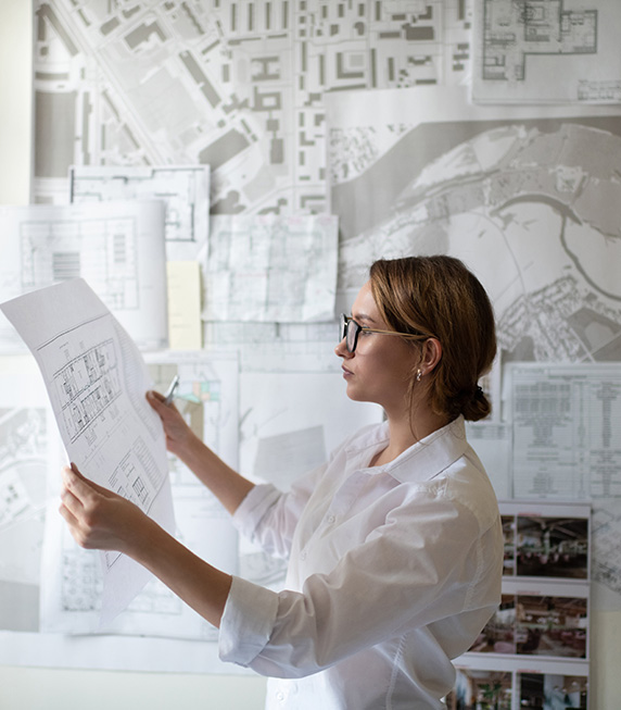 An intelligent female architect analyzing a floor plan