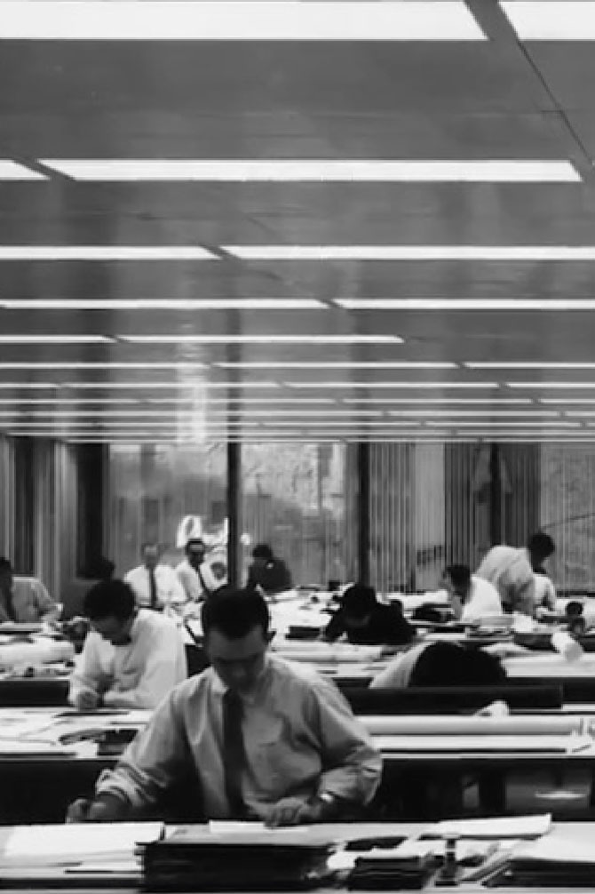 Historical black and white photo of tenants working in a office