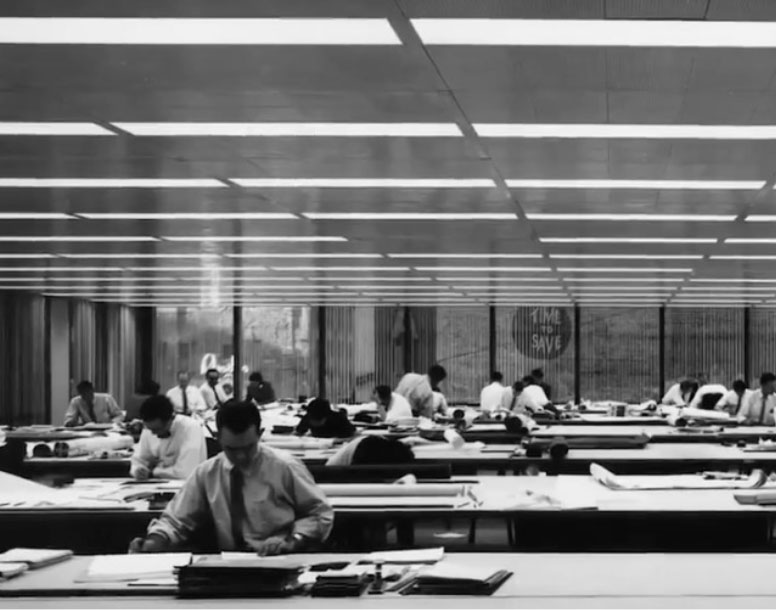 Historical black and white photo of tenants working in a office